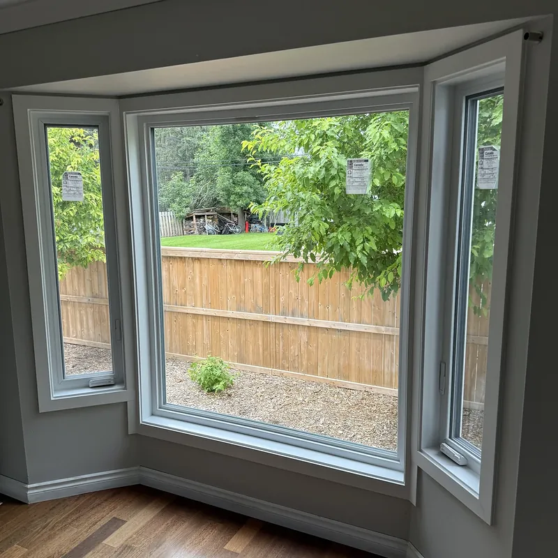 Bay window from inside: a large picture window between two casements