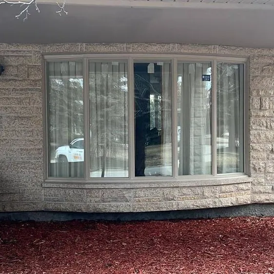 Bow window on a stone-clad home