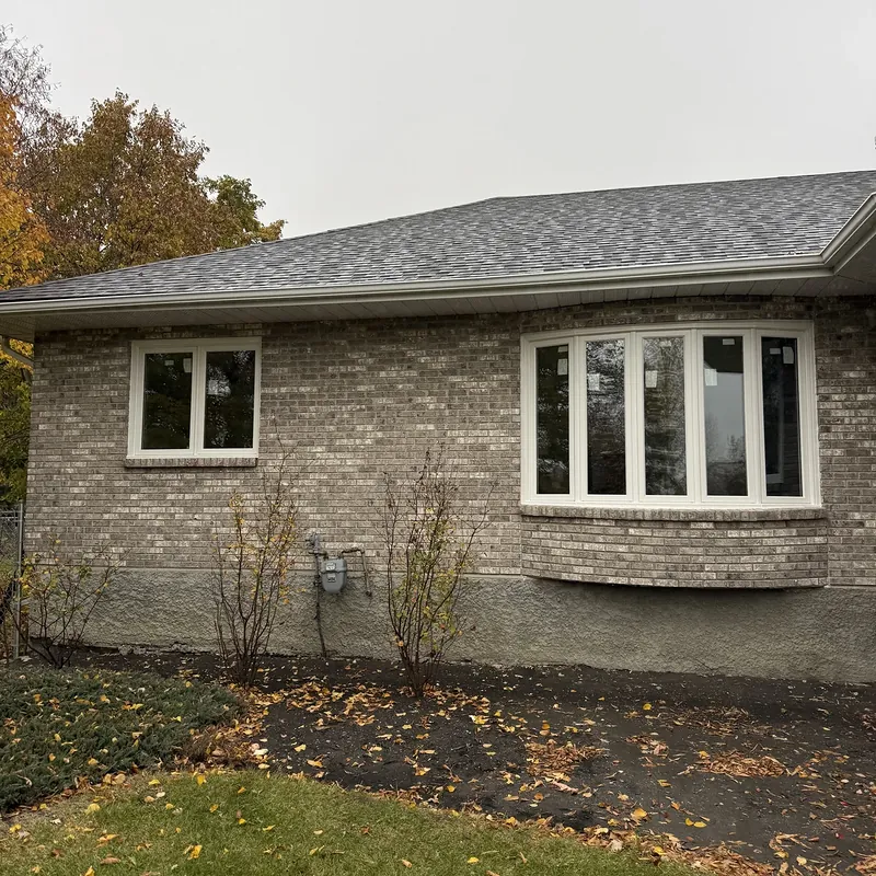Brick bungalow with a new bow window and a smaller two-section window