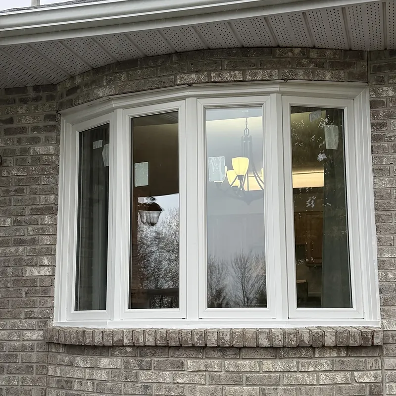 New bow window on a grey brick wall