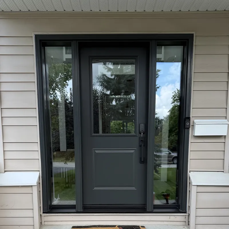 Charcoal front door with a half-glass insert and two full-length sidelites
