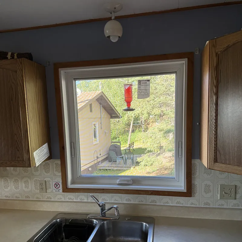 Kitchen awning window over the sink, with a hummingbird feeder outside
