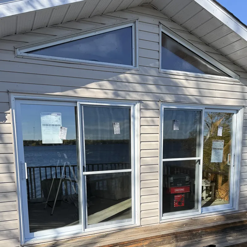 Lakeside cottage with two new sliding patio doors and shaped gable windows