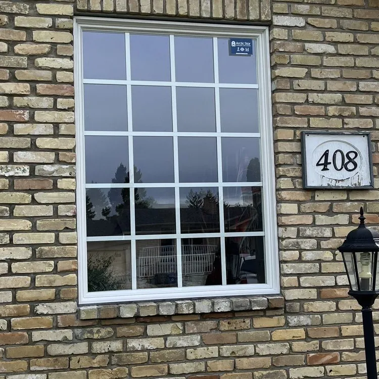 Picture window with grilles on brick