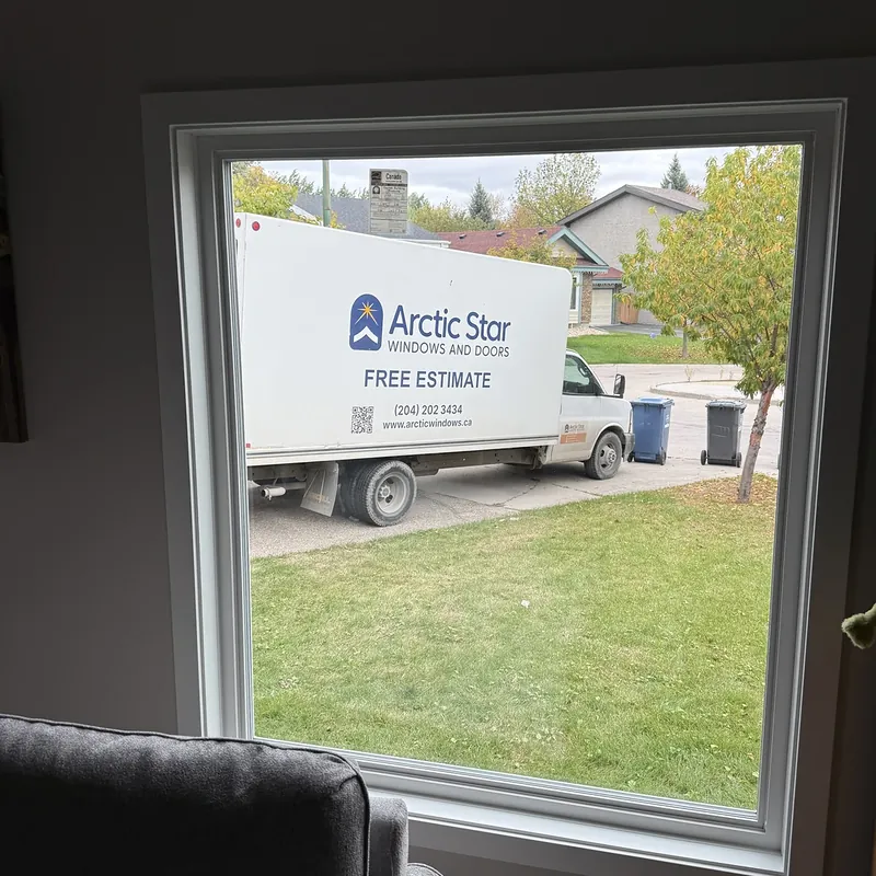 Large picture window seen from inside, with the Arctic Star truck parked outside
