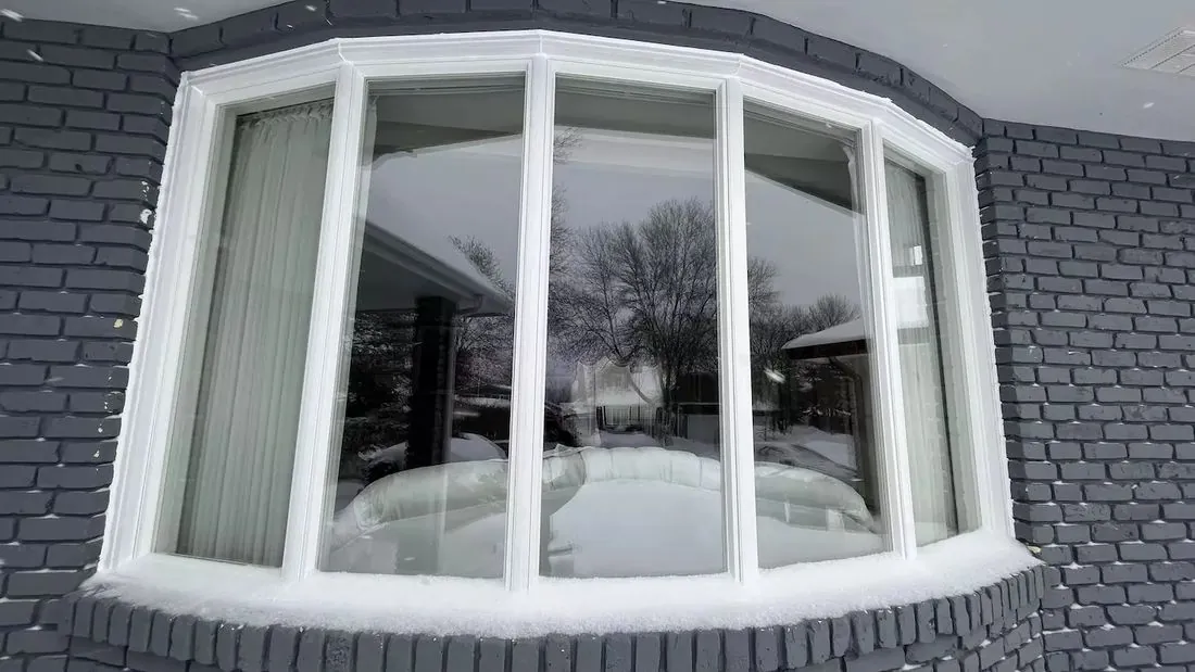 Bow window installed on a brick home in winter