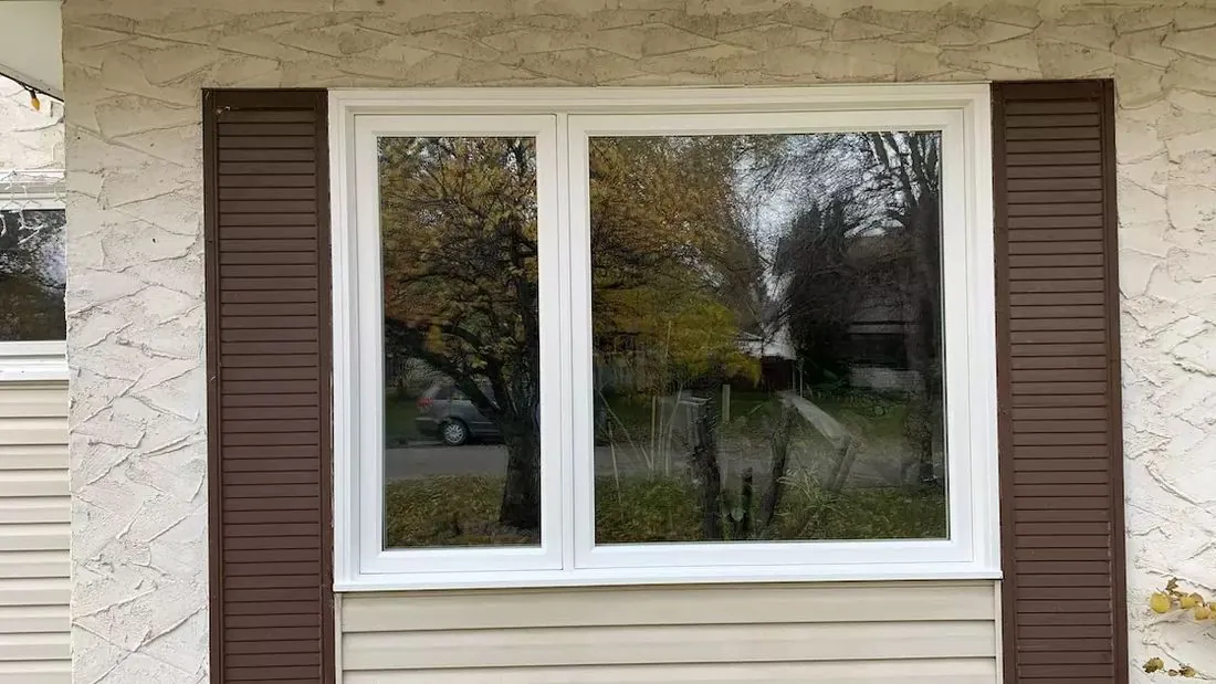 White casement and fixed window with shutters